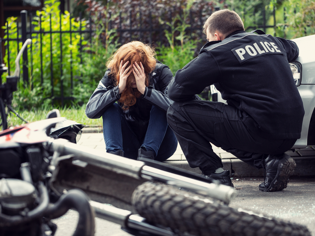 police officer talking to motorcycle crash victim