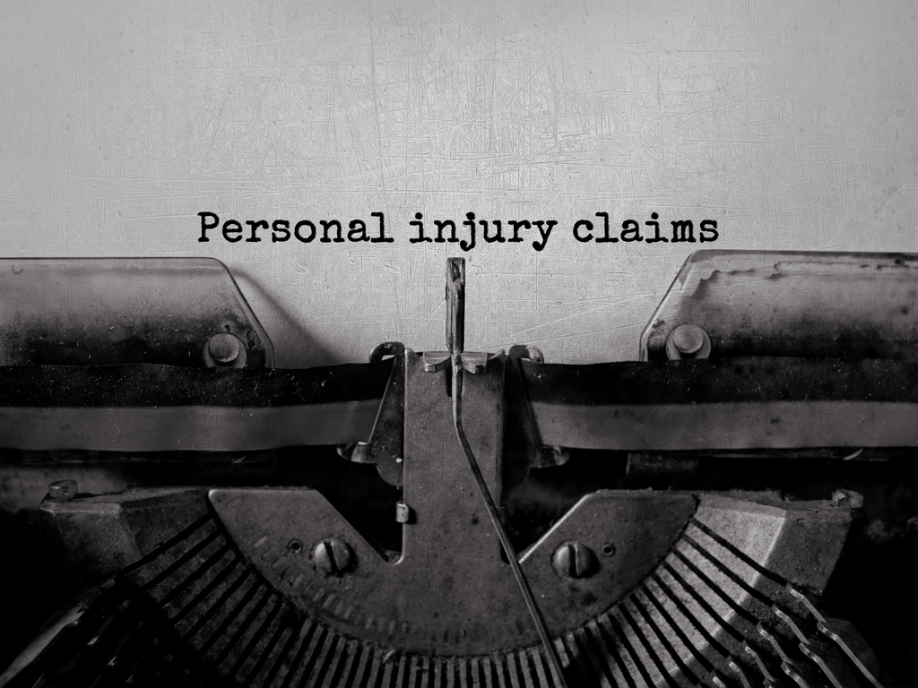 words "Personal Injury Claims" on a typewriter