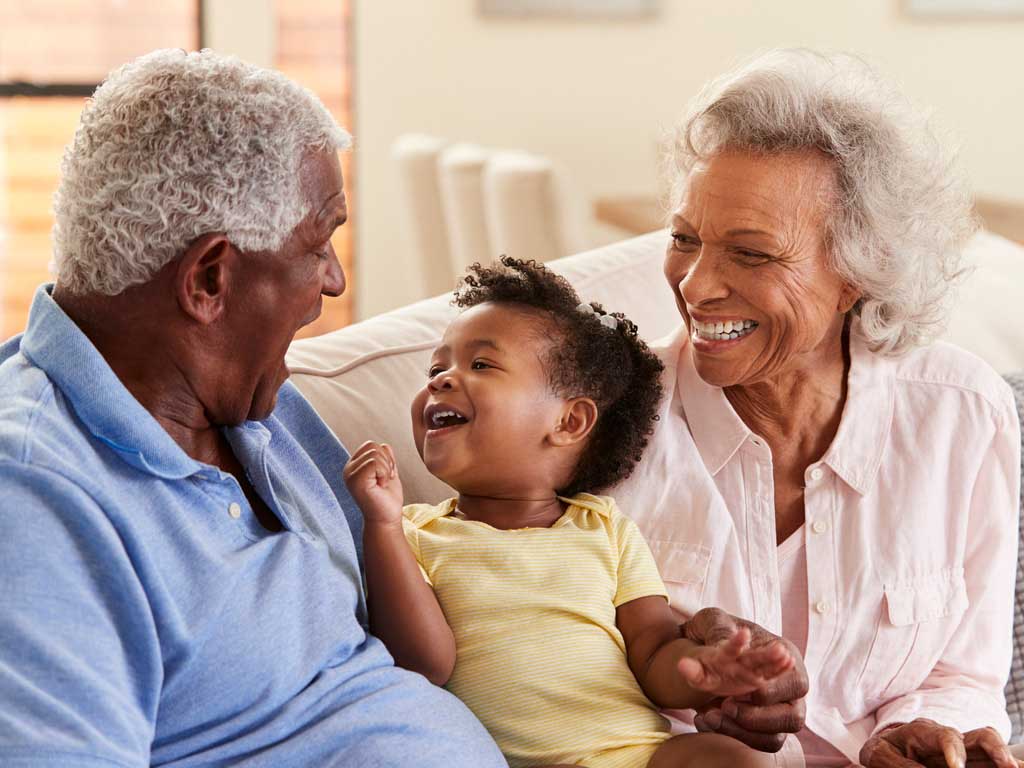 grandparents laughing with grandchild