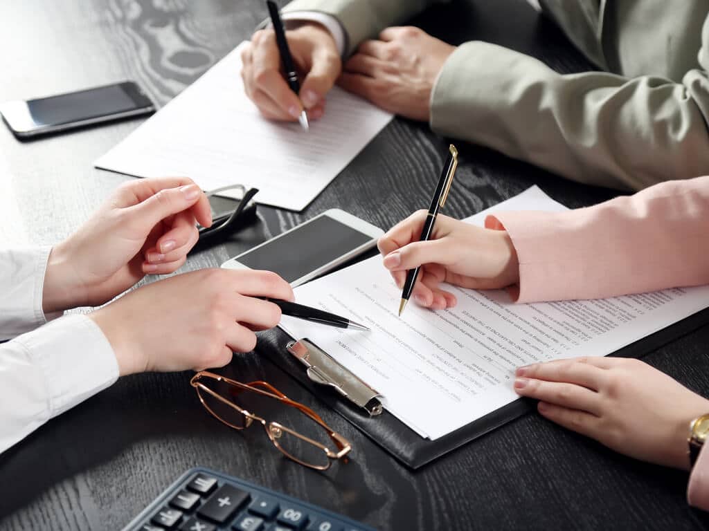 people reviewing legal documents to contest a will