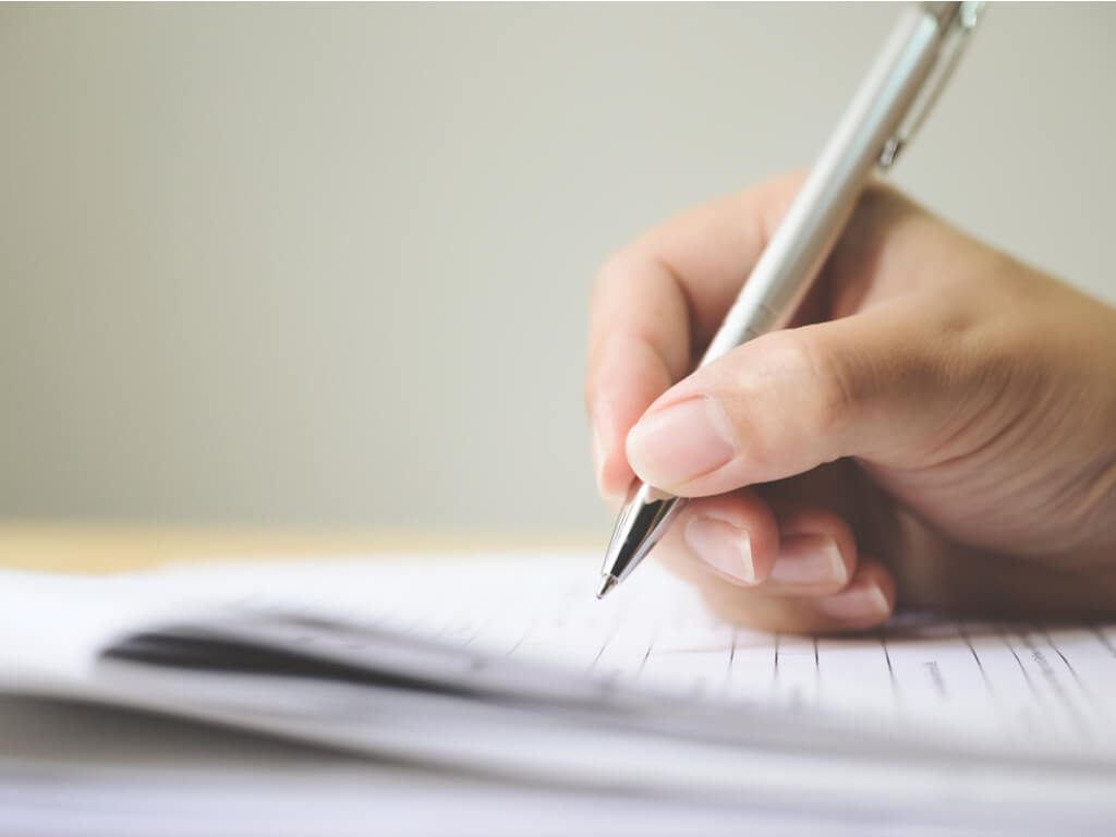 hand signing a trust