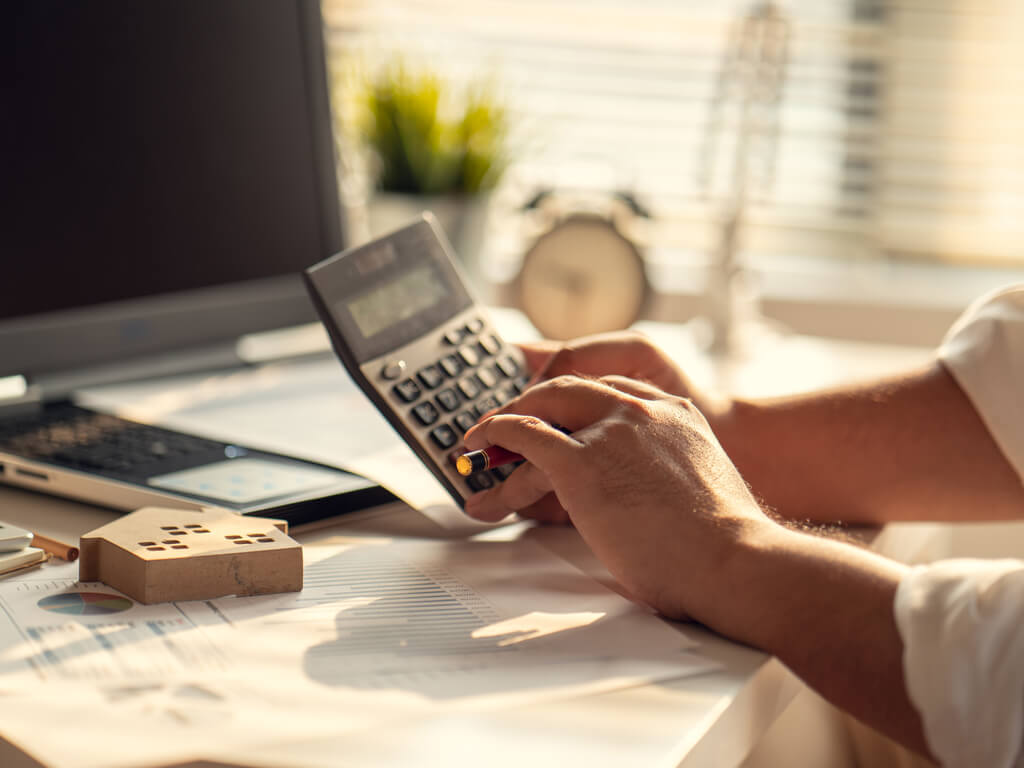 a person using a calculator to value assets
