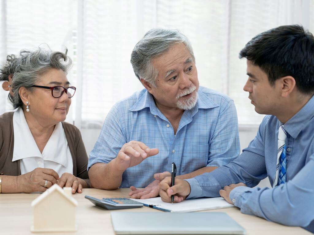 married couple speaking to estate planning attorney