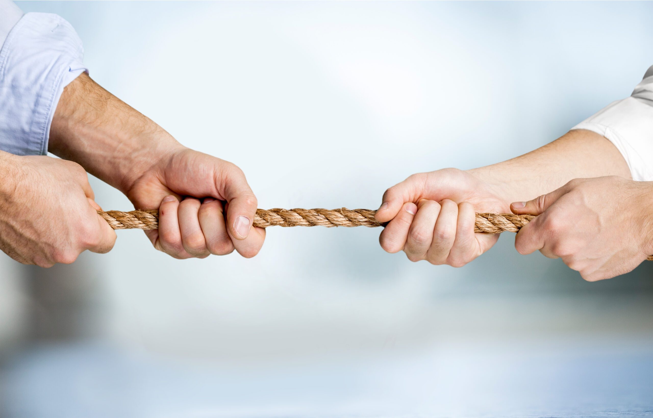 Two business succession lawyers playing tug of war