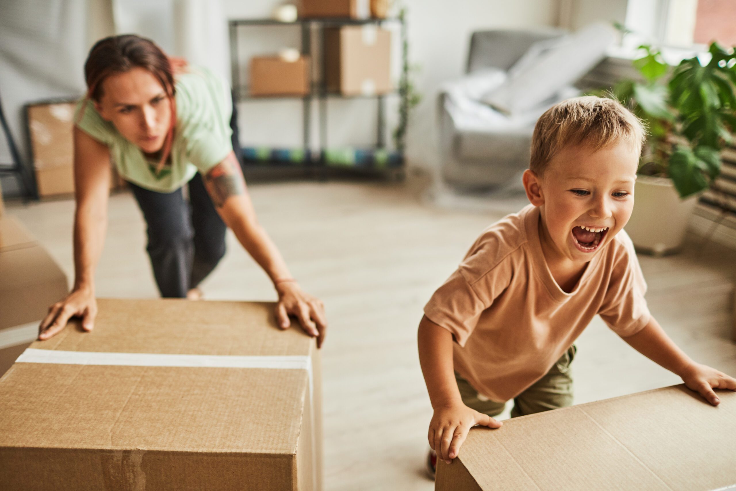 Family moving boxes after settling with a child relocation attorney