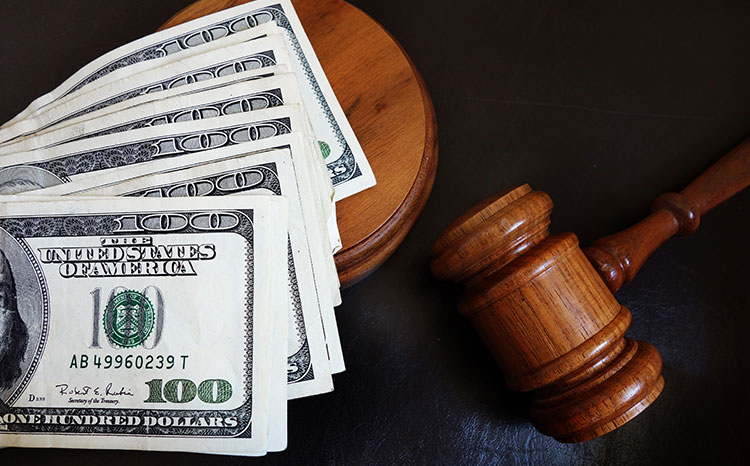 Gavel with money saved after child support modification